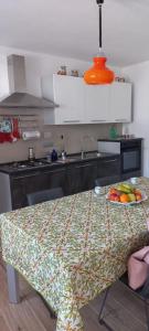 a kitchen with a table with a bowl of fruit on it at Casa Bino in Purgèssimo