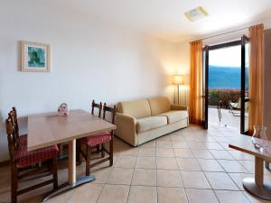a living room with a couch and a table at Residence Besass, GTSGroup in Tignale