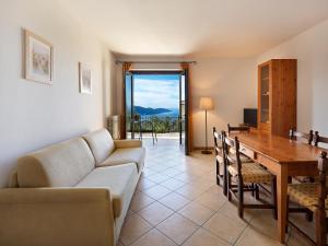 a living room with a couch and a table at Residence Besass, GTSGroup in Tignale