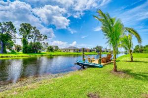 a boat on a river with a palm tree at Spacious Waterfront 6 Bedroom Duplex in lovely Rotonda West near oceans ,Golfing, Park Pool in Rotonda West