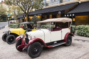 two old cars parked next to each other on a street at Plaza Madeleine & Spa in Sarlat-la-Canéda