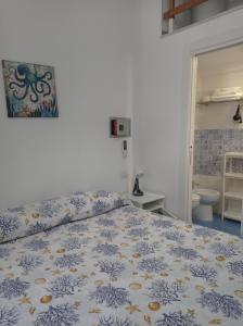 a bedroom with a bed and a bathroom at Sea House Kamaraton in Marina di Camerota