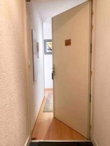 a hallway with a door leading to a room at Appartement T2 Les papillons in Arcachon