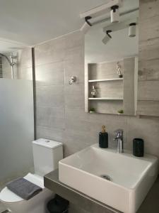 a bathroom with a white sink and a toilet at Ma Maison Nafplio in Nafplio +21 photos