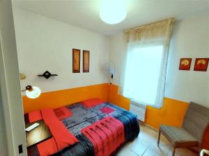 a bedroom with a bed and a desk and a window at La belle histoire in Montignac +23 photos