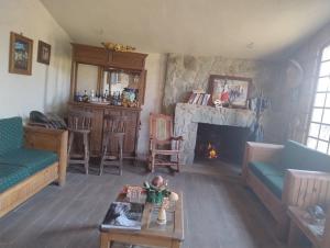 a living room with a couch and a fireplace at Rancho Tlalinantli in San Miguel Ajusco