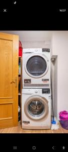 a washer and dryer in the corner of a room at may in Vihtra