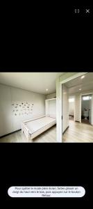 a bedroom with a bed and a large mirror at La Maison du haut! in Sainte-Rose