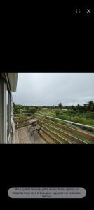 a view of a deck with benches on a balcony at La Maison du haut! in Sainte-Rose