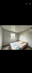 a bedroom with a bed and a window at La Maison du haut! in Sainte-Rose