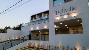 a building with a sign that reads bellville furnished at BellVille Pousada in Capitólio