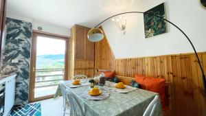 a dining room with a table with oranges on it at Artemide Domus in Pescocostanzo