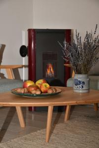 a plate of fruit on a table in front of a fireplace at Gästehaus Eifelsteig in Schleiden +5 photos