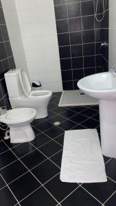 a bathroom with a toilet and a sink at Hotel Velipoja Park in Velipojë +16 photos