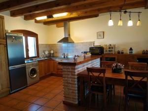 a kitchen with a table and a stove top oven at La casita de Duratón in Duratón