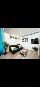 a bedroom with a bed and a table in it at Glycine in Orléans