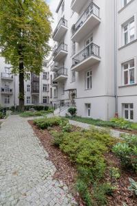 an apartment building with a walkway in front of it at Apartment with Balcony - Starowiślna 41 in Kraków