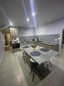 a kitchen with a table with chairs and an oven at Maison de village spacieuse et calme in Tréveray