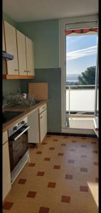 a kitchen with a view of a large window at Blue Paradise in La Ciotat +7 photos