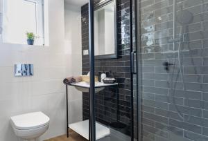 a bathroom with a shower and a toilet and a sink at SoleOle in Playa de Gandia +84 photos