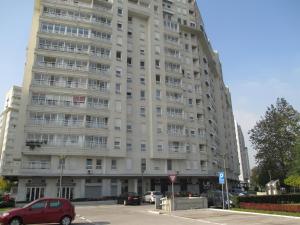 a large building with a red car parked in front of it at Apartments Belville in Belgrade