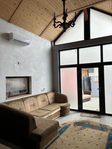 a living room with a couch and a fireplace at La FRU2 in Zărneşti