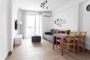 a living room with a table and a couch at SoleOle in Playa de Gandia