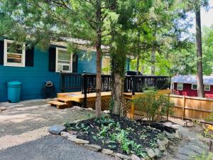 a blue house with a tree in front of it at Mountain Lake Retreat - hot tub, lake, fire pit, wineries, restaurant in Harpers Ferry