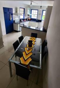 a kitchen with a glass table with chairs and a counter at Casa Carmo in Ouro Preto +14 photos