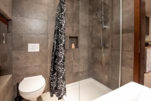 a bathroom with a shower and a toilet at Apartments Kosir in Kranjska Gora +51 photos