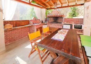a table and chairs in a kitchen with a brick oven at Hermes villa Possidi in Possidi