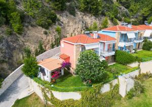 an aerial view of a house with a mountain at Hermes villa Possidi in Possidi