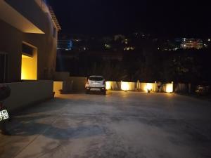 a car parked in a parking lot at night at SeaEsta Vasiliki 1 in Póndi +2 photos