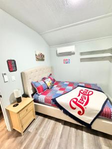 a bedroom with a bed and a night stand at Route 66 Pop Stop-Minutes to Main St in Bandera