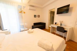 a bedroom with a bed with a desk and a chair at Near Vatican, Irnerio 47 Guest House in Rome