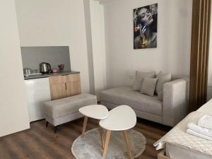 a small living room with a couch and a table at Valentina Apartament in Negotino