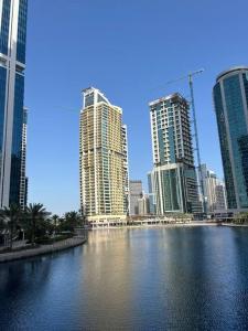 a city with tall buildings and a body of water at What a view - very close to DMCC metro station in Dubai