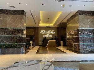 a lobby of a luxury hotel with a table and dance sign at What a view - very close to DMCC metro station in Dubai +13 photos