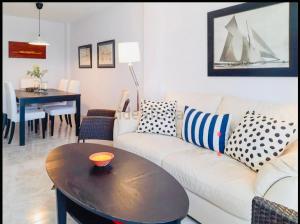 a living room with a white couch and a table at LMHA25, Puerto Latino 11, Tomas Maestre Marina, La Manga in La Manga del Mar Menor