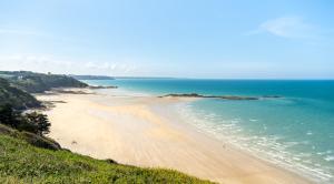 a view of a beach with people in the water at Ker Breizh in Saint-Brieuc