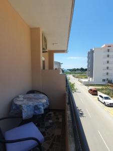 a room with a balcony with a bed and a street at Apartments Luna in Bar