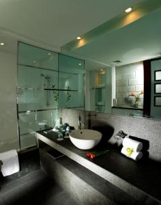 a bathroom with a sink and a large mirror at Villa Rotana - Dubai in Dubai