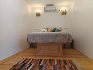 a bedroom with a bed and a rug at El Sama' family house Rooftop 80m2 in Chefchaouene +34 photos