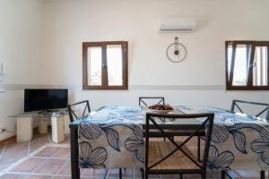 una stanza con un letto, un tavolo e una tv di Rosemarine Corda a Favignana