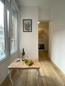 a table with a glass of wine and fruit on it at Comfort studio Lepa Kata in Podgorica