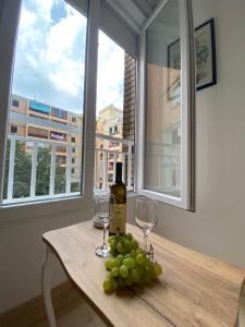 a table with a bottle of wine and two glasses at Comfort studio Lepa Kata in Podgorica