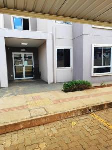 a large white building with a entrance to a building at Apartamento confortável in Campo Grande +7 photos