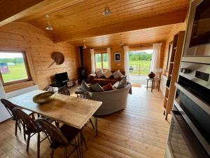 a living room with a couch and a table at The Alpaca Cabin in Westbourne