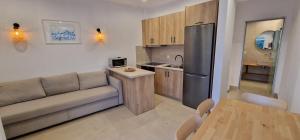 a living room with a couch and a kitchen at IVANKA'S VILLAS in Skala Rachoniou