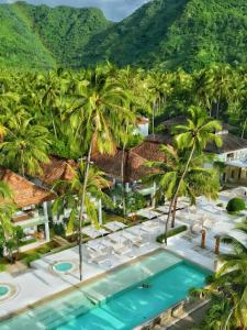 an aerial view of a resort with a pool and palm trees at Seven Secrets by Hanging Gardens in Senggigi